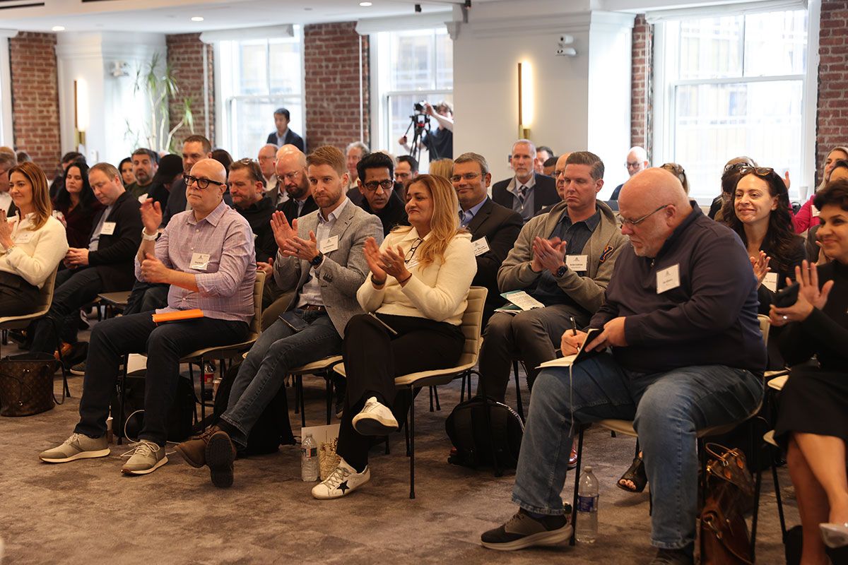 Attendees applauding during an AI Trailblazers summit session
